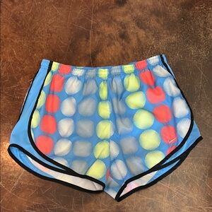Women’s Nike running shorts blue with orange and yellow circles. Size Medium.